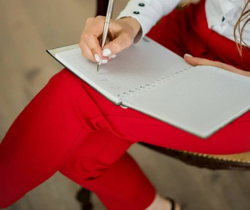 Psychotherapist writing notes in a journal
